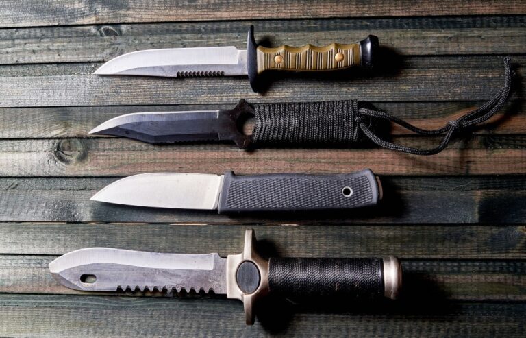 A set of knives on a dark wooden background